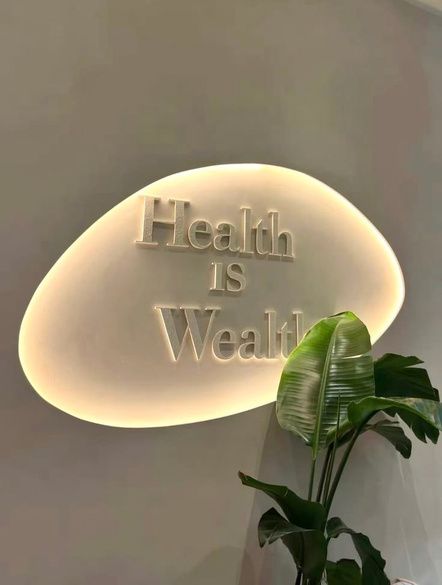 Backlit wellness sign reading Health is Wealth